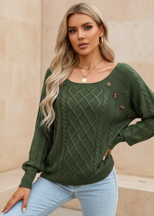 Woman wearingAnya green sweater with button details against a beige wall.