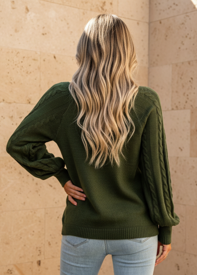 Person wearing Anya green sweater with a neutral background
