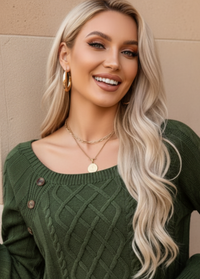 Woman wearing Anya green sweater with a beige background