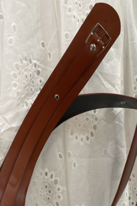 Naiya Brown belt with a silver buckle on a white lace background
