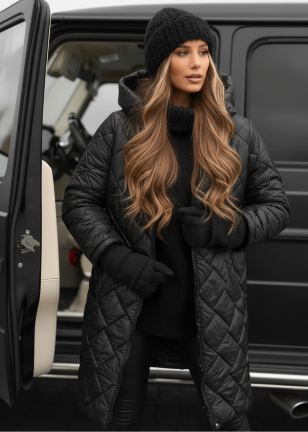 Woman in a black quilted coat and beanie standing next to a car.