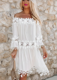 Woman wearing Diaz white off shoulder mini dress