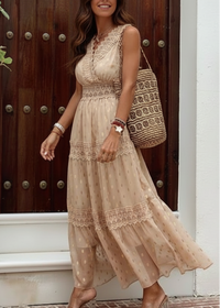 Woman wearing Indra Nude lace dress standing in front of a wooden door.