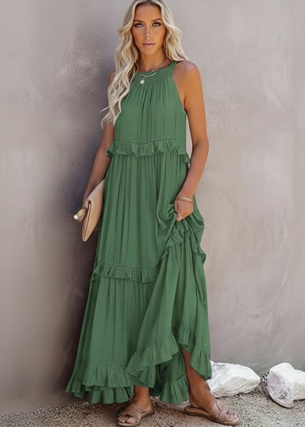 Woman wearing a green dress standing against a neutral background