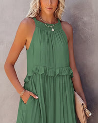Woman wearing a green dress against a neutral background
