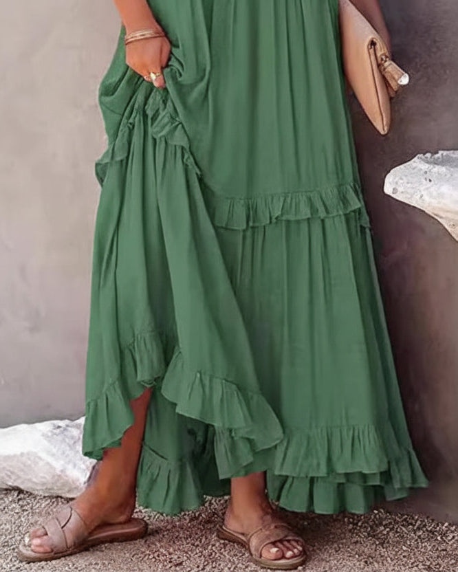 Green dress with ruffled layers worn by a woman
