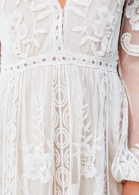 Close-up of a white lace dress with intricate patterns
