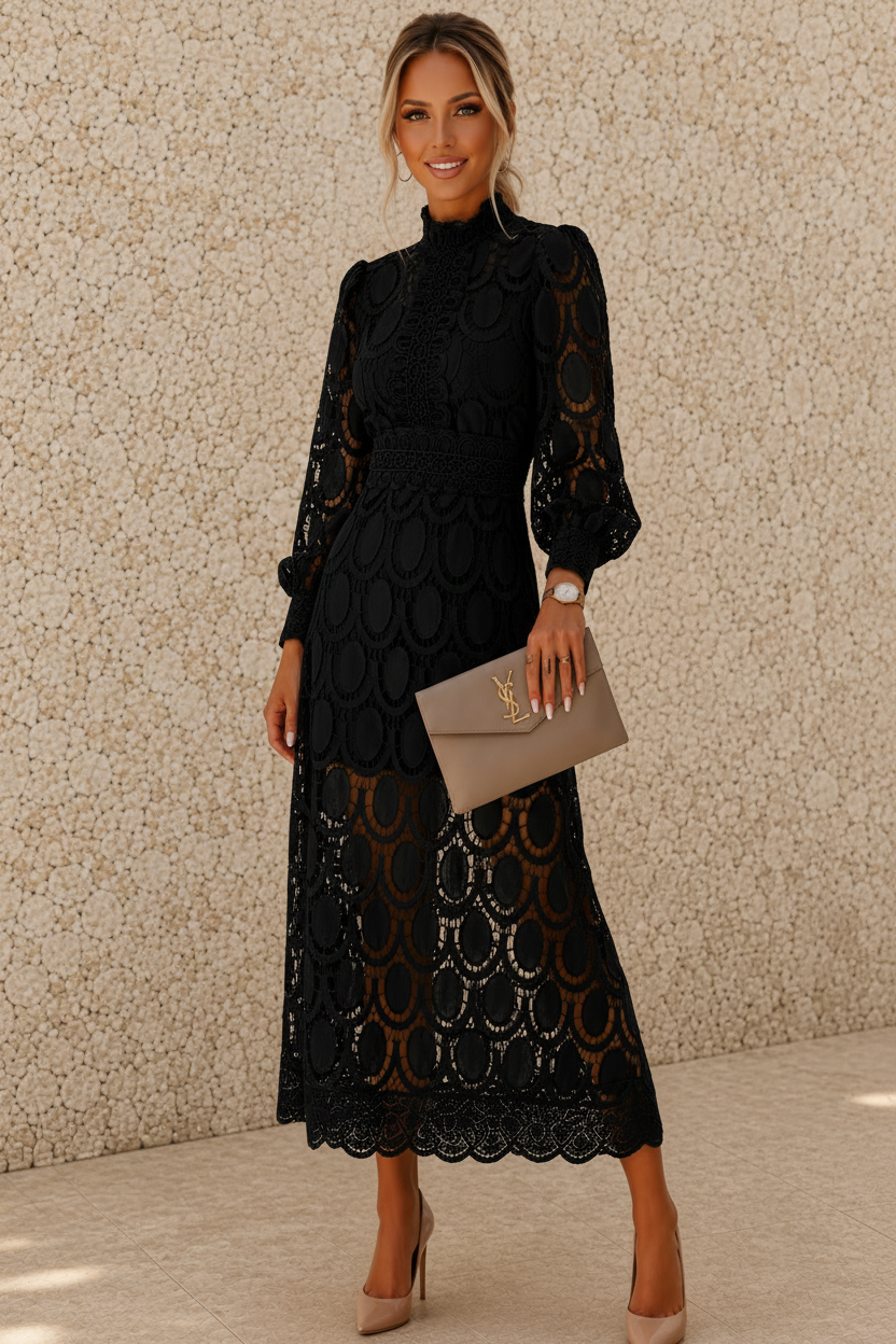A woman models a black long-sleeve midi dress with a high mock neck and a scalloped lace hem, holding a taupe clutch bag against a textured beige wall.