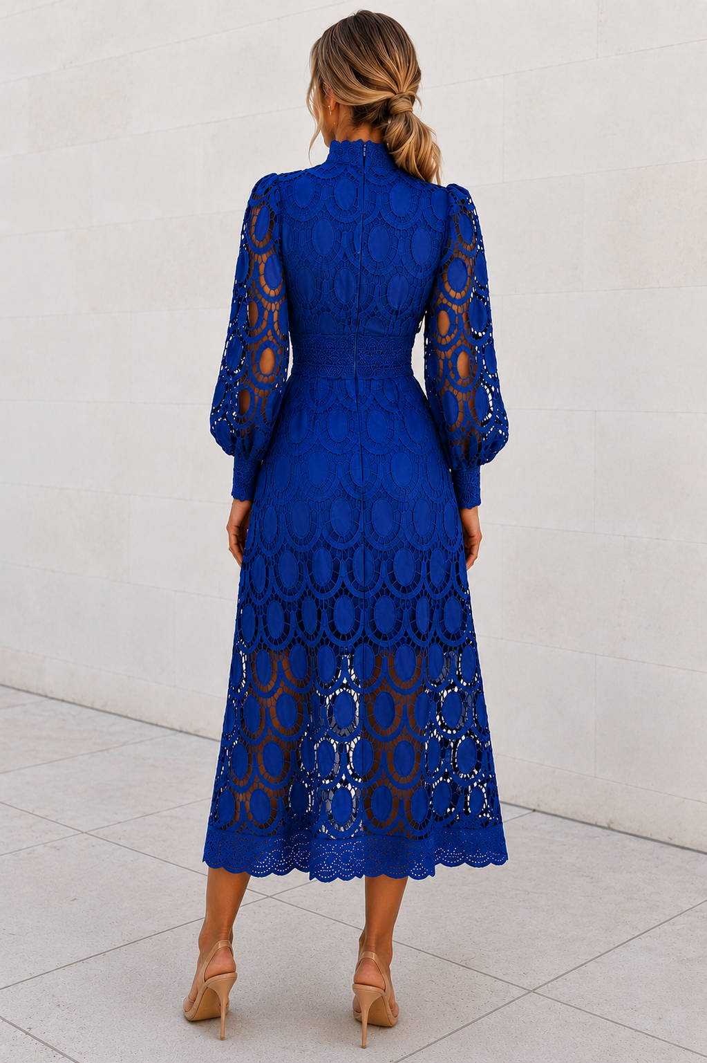 Woman wearing a blue lace dress against a white background