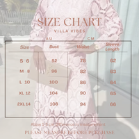 Villa VIbes Size chart for clothing with measurements in AU and CM, overlaid on a blurred background of a person wearing a dress.