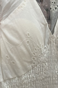 Naiya White embroidered top with intricate patterns on a plain background