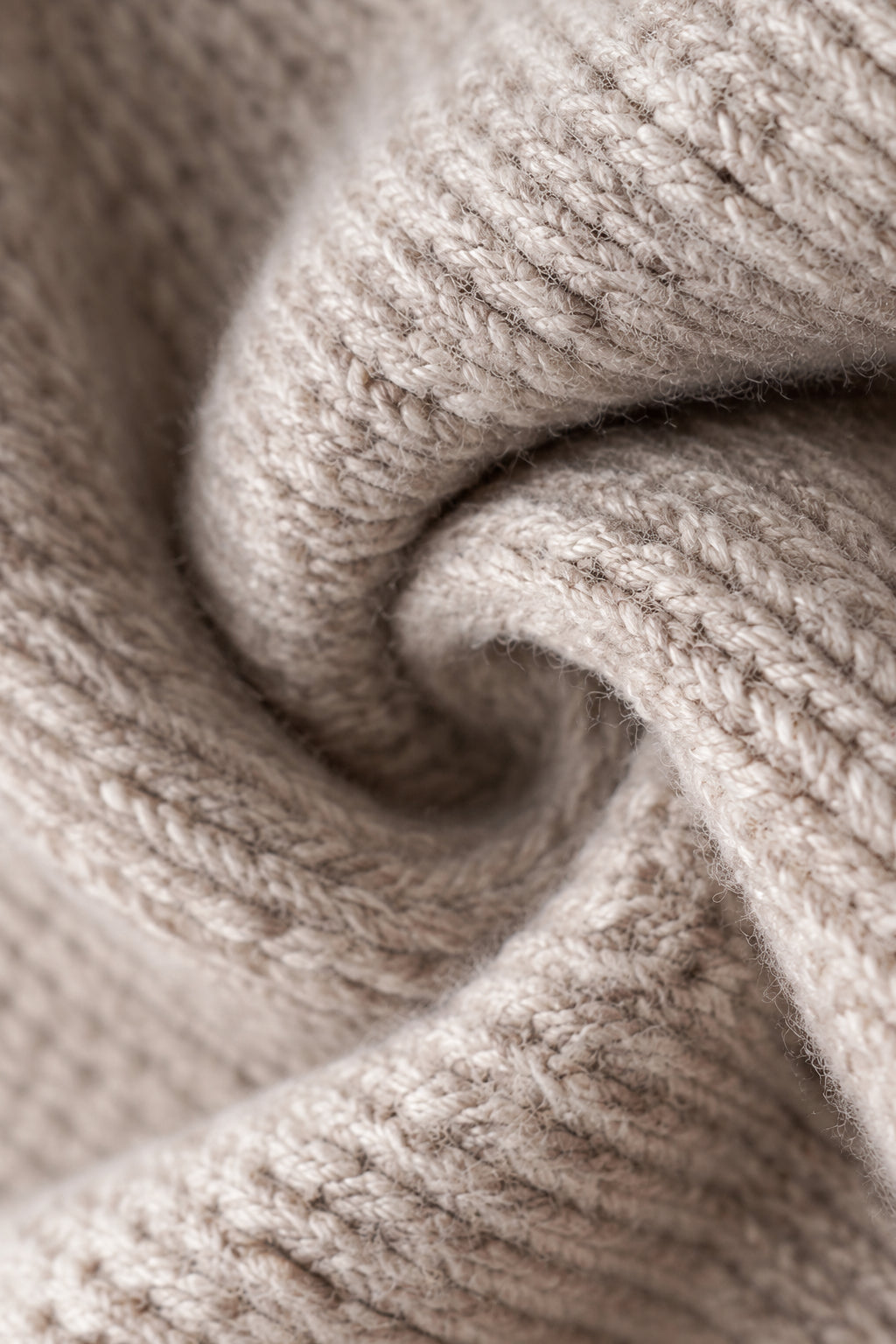 Close-up of a knitted fabric of Peyton Jumper with a beige color.