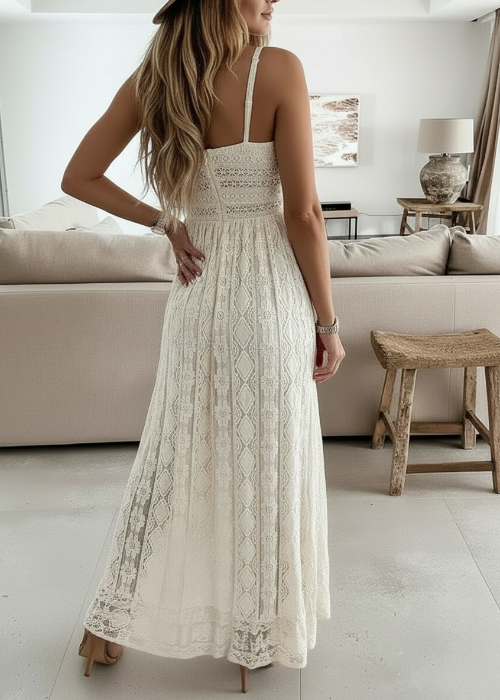 Woman wearing a white lace dress in a modern living room.