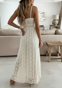 Woman wearing a white lace dress in a modern living room.