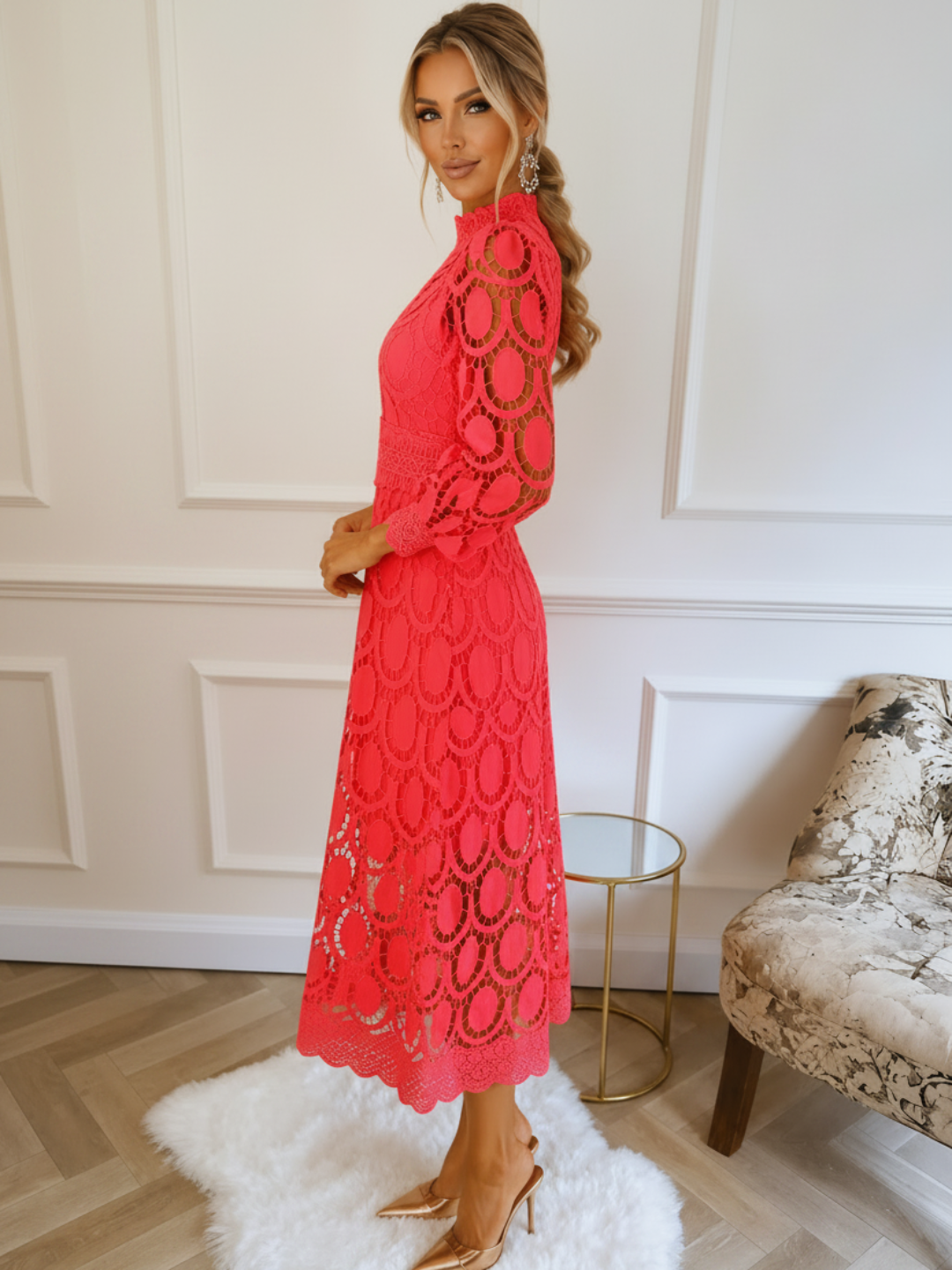 Woman in a Villa Vibes Jasmine Corallace dress standing in a stylish room with decor elements.