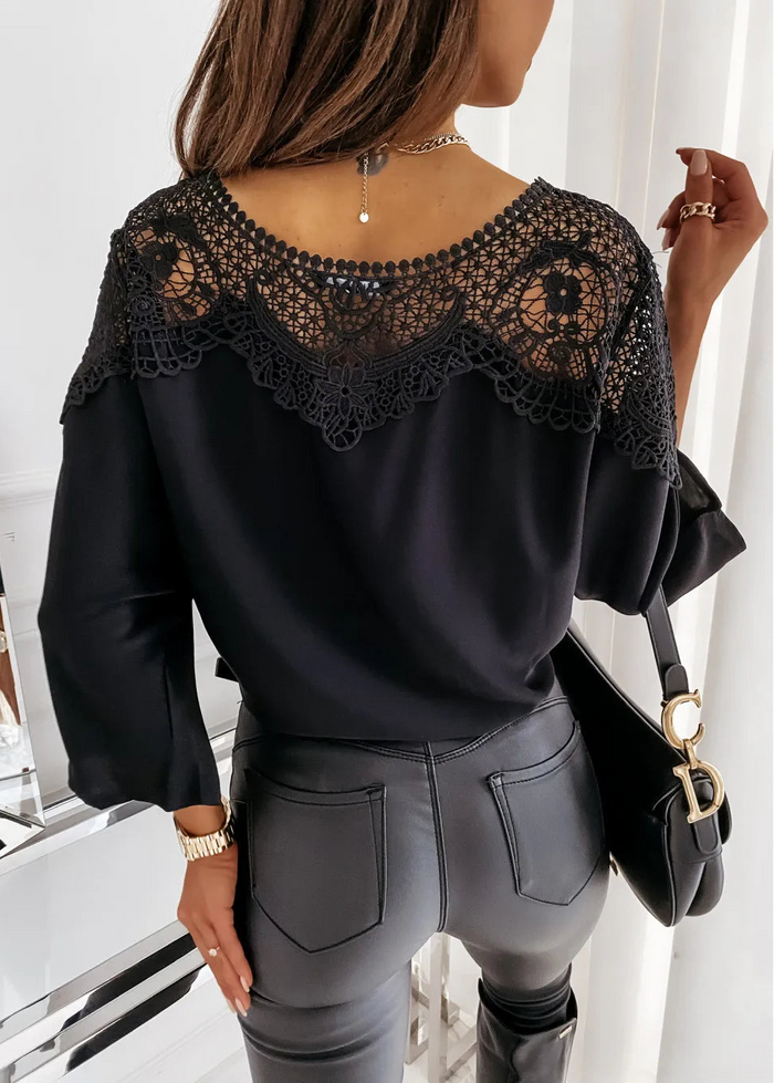 St Barts Black Lace Top with lace detailing worn by a person, sitting on a white chair.