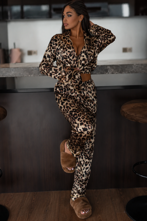 Woman in Villa Vibes Midnight leopard print outfit sitting on a kitchen counter.