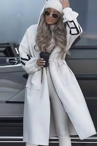 Person wearing a Villa Vibes Kelly long white coat with a car in the background
