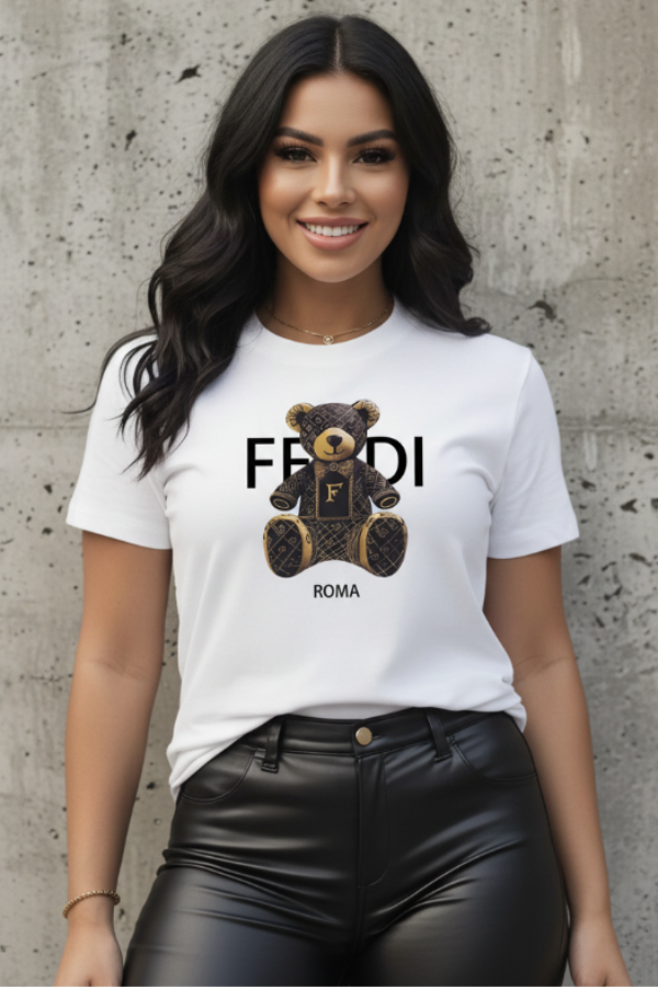 Woman wearing a Villa VIbes Designer white t-shirt with a teddy bear and 'Fendi' logo against a concrete wall.