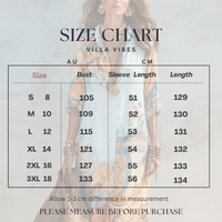 A size chart graphic for Villa Vibes Alanna Geo Print Dress, showing a table with sizes S through 3XL, bust measurements in AU and CM, sleeve length, and garment length. A woman in a blue and orange patterned dress is faintly visible in the background behind the table.
