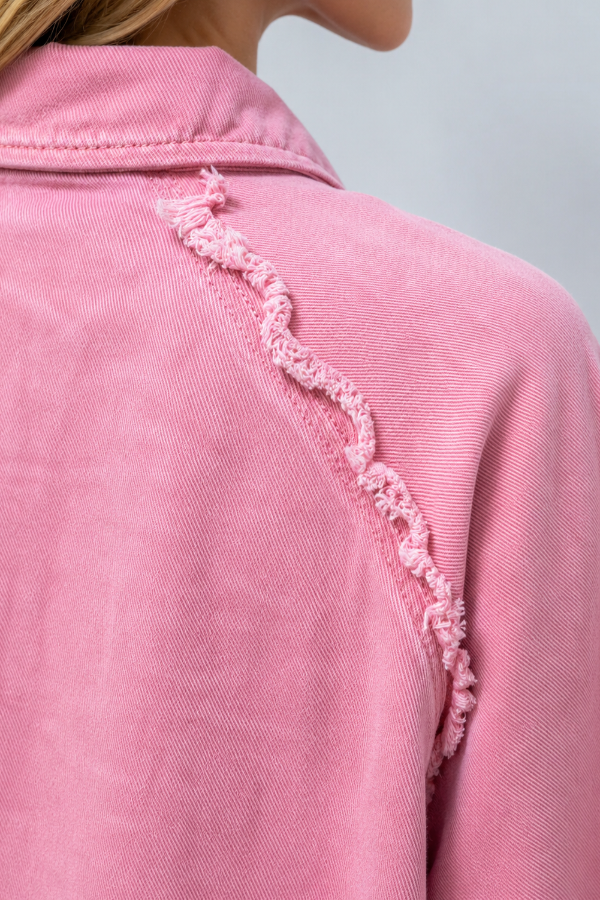 Close-up of a Villa Vibes Brydie  pink garment with lace trim on a plain background