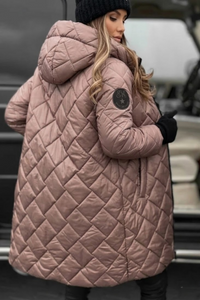 Person wearing a Villa Vibes Cameron pink quilted coat with a blurred background
