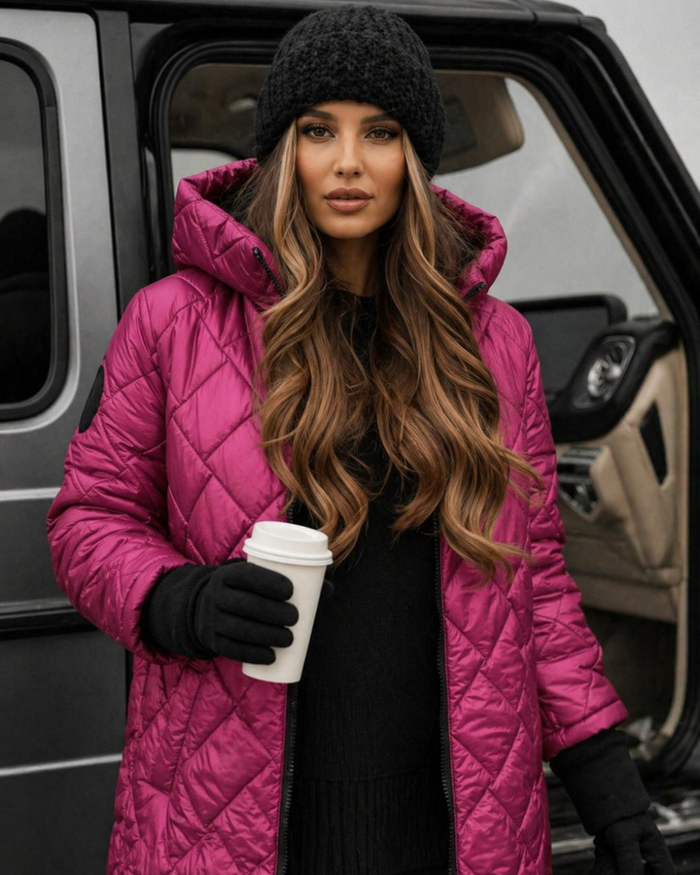 Woman in a Villa Vibes Cameron Rose quilted coat holding a coffee cup, standing next to a vehicle.