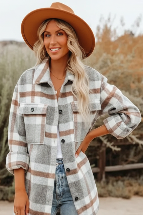 Woman wearing a Villa Vibes Cassidy plaid shirt and hat in a desert-like setting