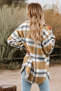 Woman wearing a Villa Vibes Cassidy plaid jacket in a natural setting
