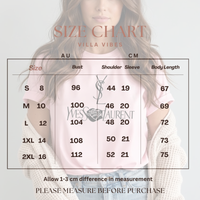 A size chart graphic for Villa Vibes Designer Inspired, showing a size table with measurements in AU and CM for bust, shoulder, sleeve, and body length. The background features a faded image of a woman wearing a pink Yves Saint Laurent t-shirt and a white knit cardigan.