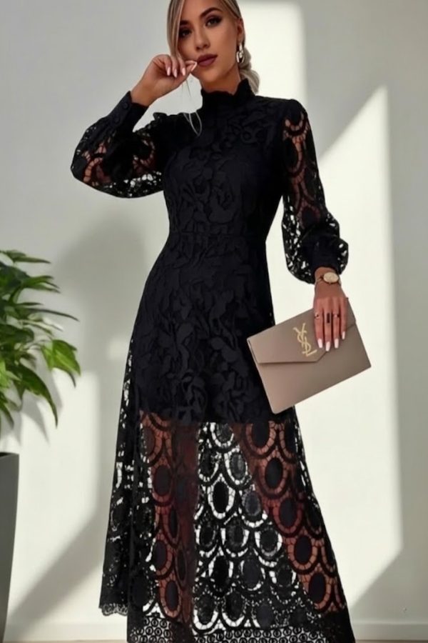 Woman wearing a Villa Vibes Jasmine black lace dress holding a beige clutch against a white wall.