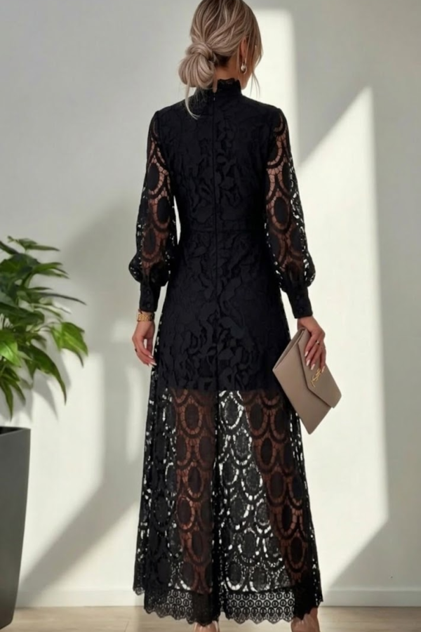 Woman wearing a Villa Vibes Jasmine black lace dress with long sleeves in a minimal indoor setting.