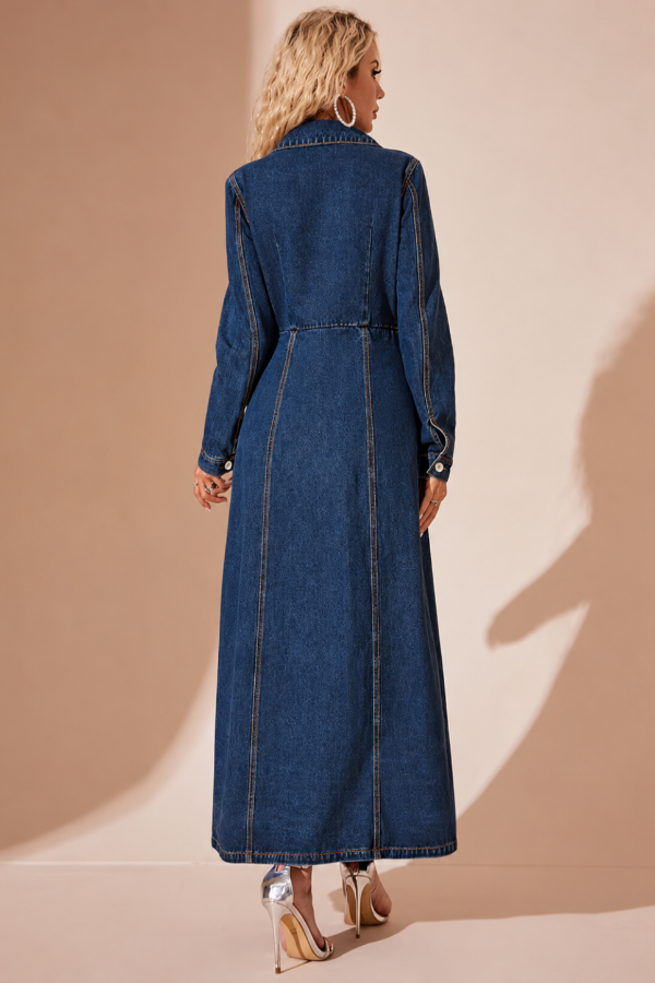 Woman wearing a Villa Vibes Jordie long denim dress against a beige background