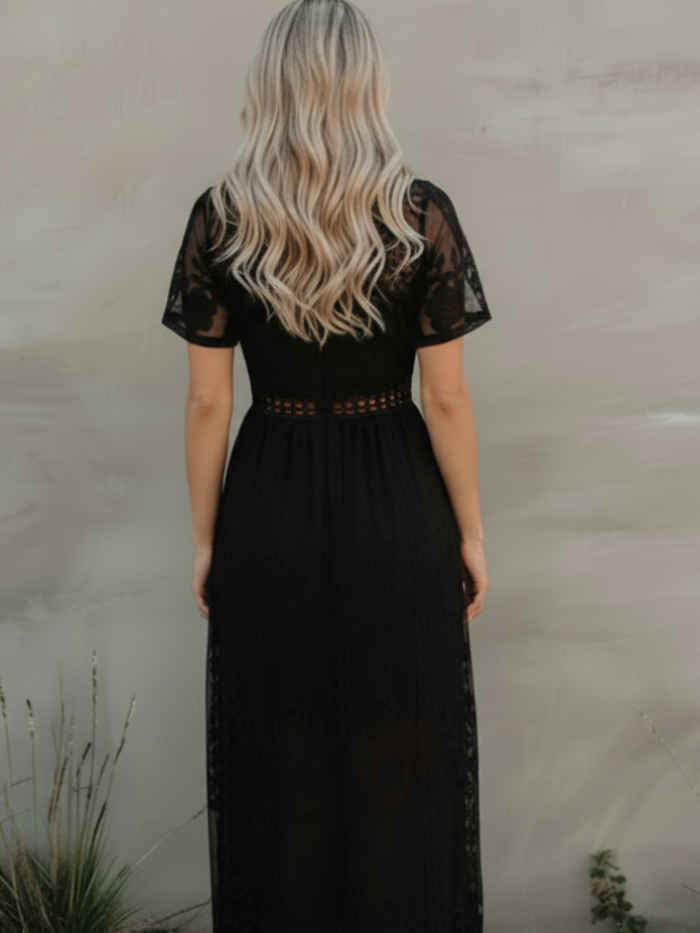 Person wearing Villa Vibes  Lotus black lace dress with a neutral background
