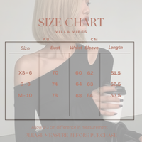 Nikki Black Top Size chart for clothing with a person wearing a gray top on a light gray background