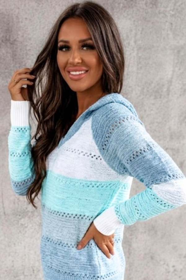 Woman wearing a Villa Vibes Pippa Blue and white crochet sweater against a gray background