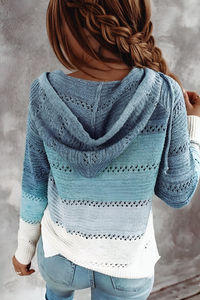 Person wearing a Villa Vibes Pippa blue knitted cardigan with a gray background