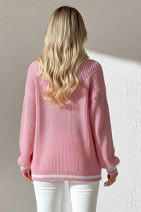 Person wearing Villa Vibes Sutton pink sweater with a neutral background