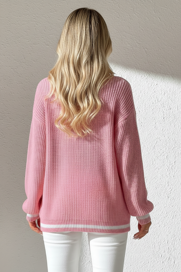 Person wearing Villa Vibes Sutton pink sweater with a neutral background