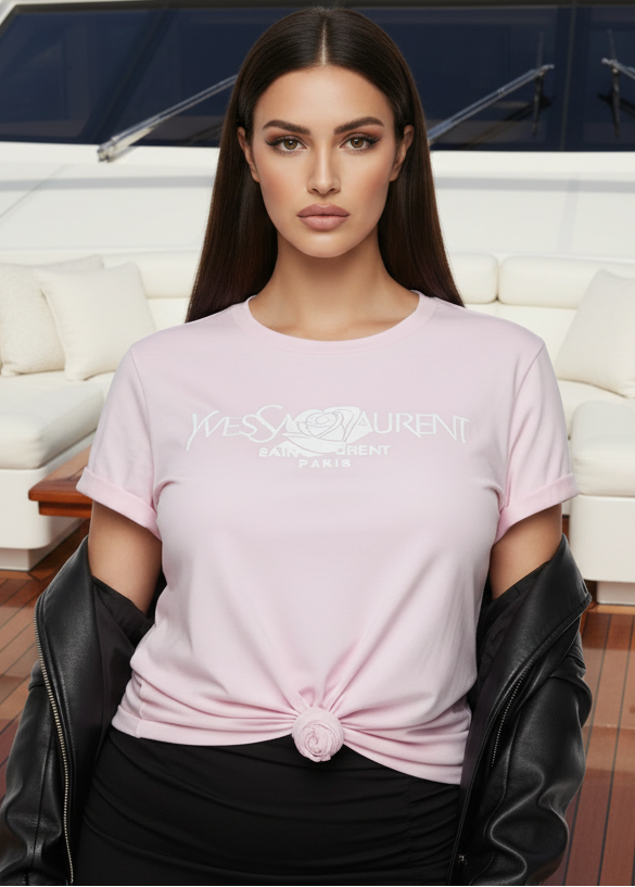 Woman wearing a pink YSL t-shirt with a brand logo in an indoor setting.
