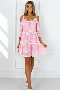 Woman wearing a Fallon pink lace dress against a white background from Villa Vibes