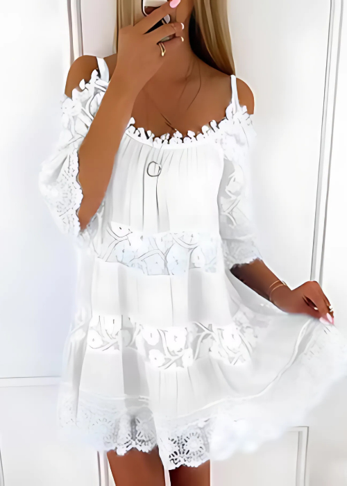 White lace dress worn by a person against a white background