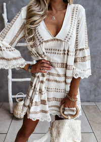 Woman wearing a white lace dress with a neutral background