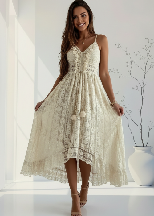 Woman wearing a beige lace dress in a bright room with a vase and plant.
