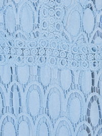 A close-up of Villa Vibes Jasmine light blue lace fabric with an intricate floral and oval pattern.